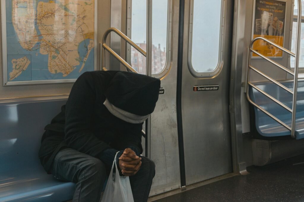 man riding a train sad or worried