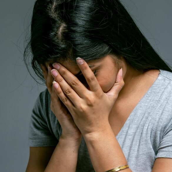 Woman Hiding Her Face in Hands