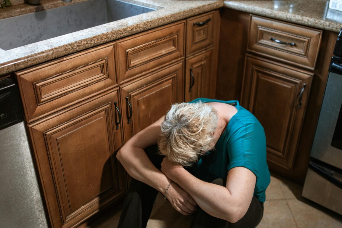 Portrait of a Woman Crying on the Kitchen Floor
