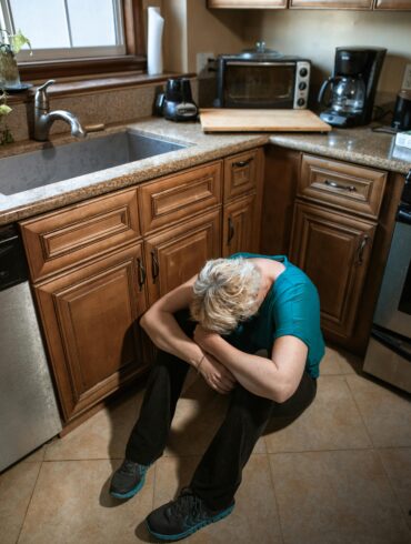 Portrait of a Woman Crying on the Kitchen Floor