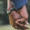 close-Up Photo of Two Person's Holding Hands